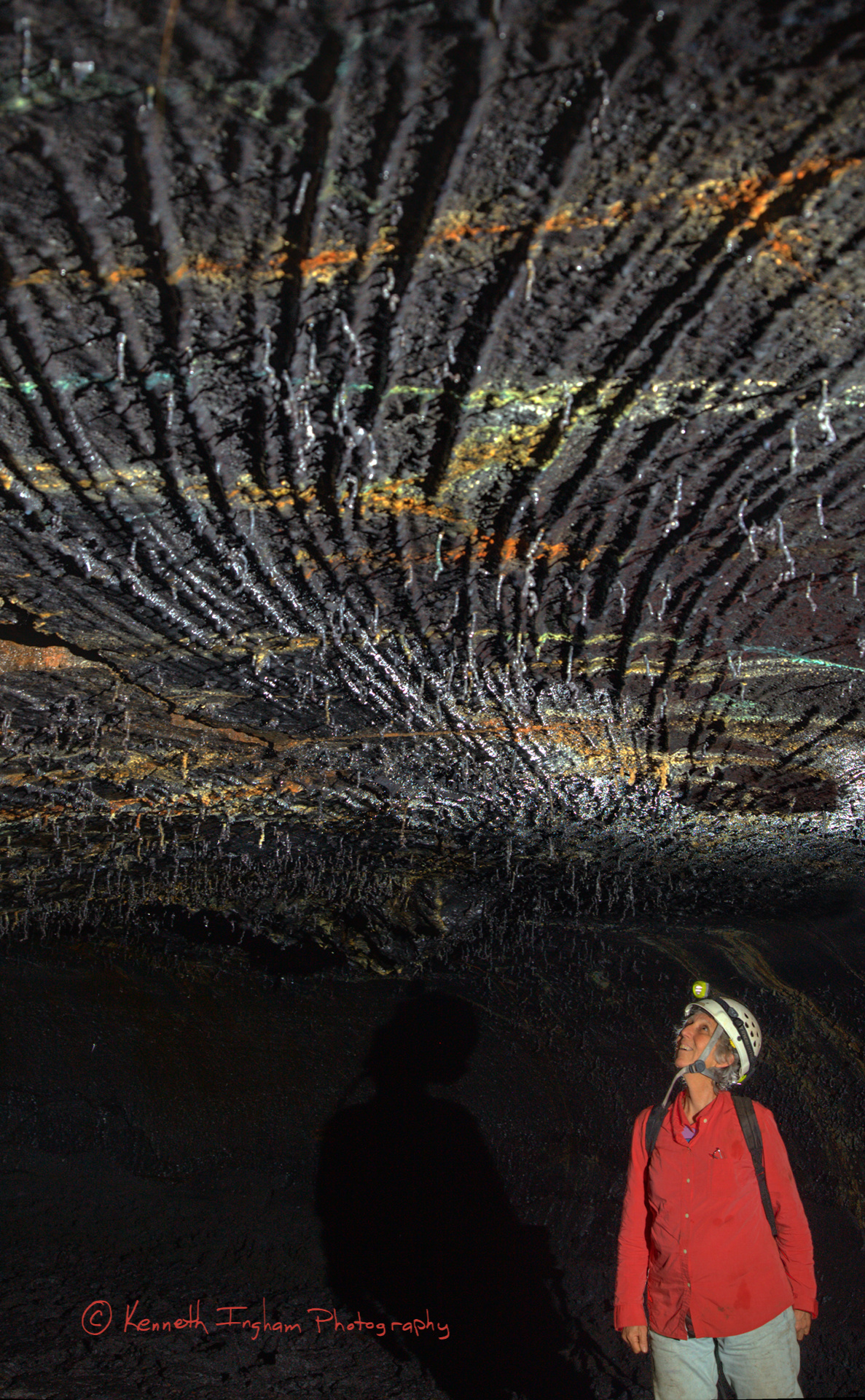 Caver looking at a corrugated lava ceiling