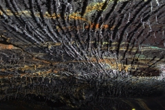 Caver looking at a corrugated lava ceiling
