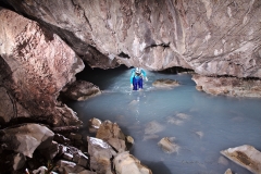 Cassie coming under a low point in the cave