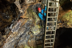 Caver on the entrance ladder