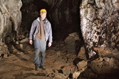 Aaron coming through the cave, reflected in a pool