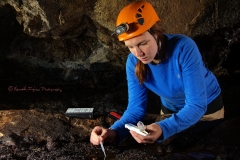 Scientist checking cave pool pH